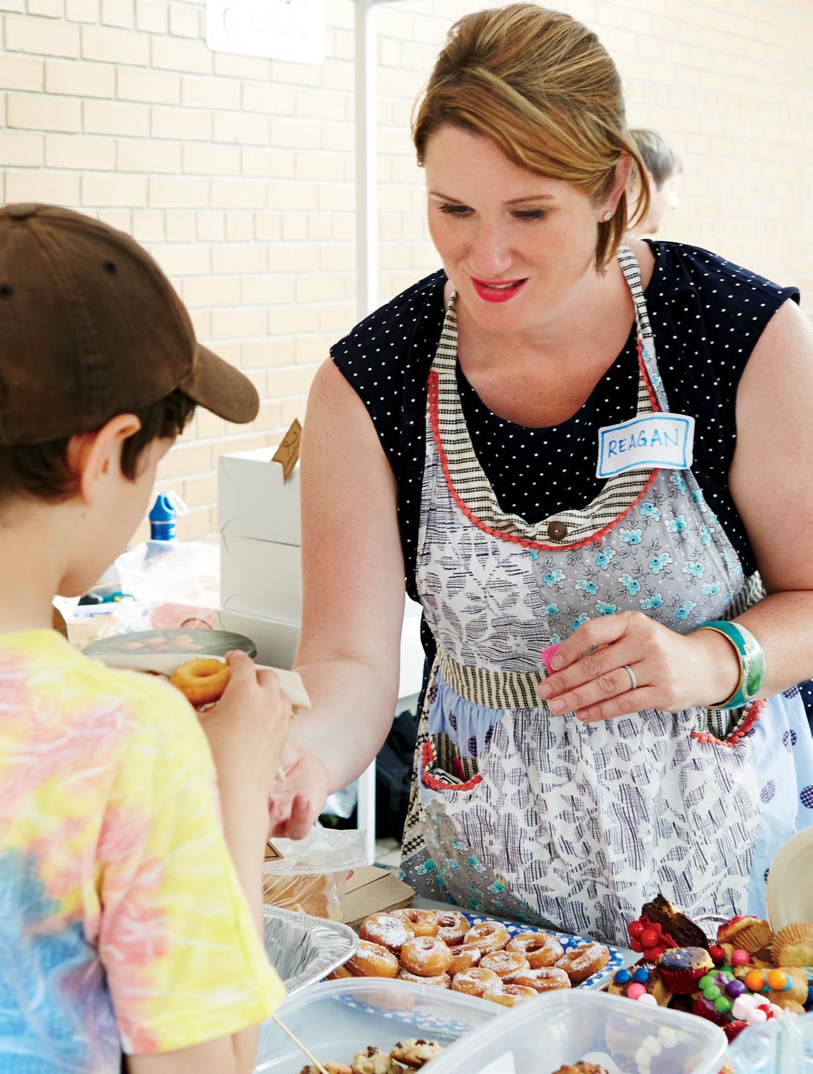 A photo collage of volunteers in action at the annual Picnic for the Arts fundraiser at Huron Street Public School in Toronto.