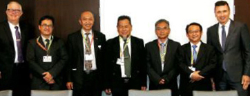 Photo of members from the Indonesian National Accreditation Board of Schools standing with Michael Saver, College accreditation administrator and Richard Lewko, director of corporate and council services.