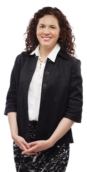 College Chair Angela De Palma standing with hands folded.