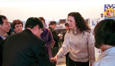A photo of College Chair Angela De Palma greeting a delegation from China.