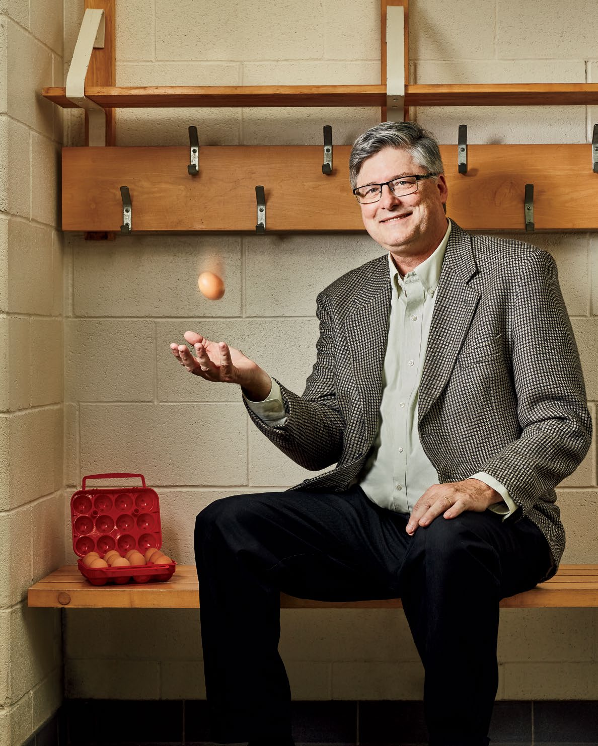 A photo of Steven Revington tossing an egg in the air.