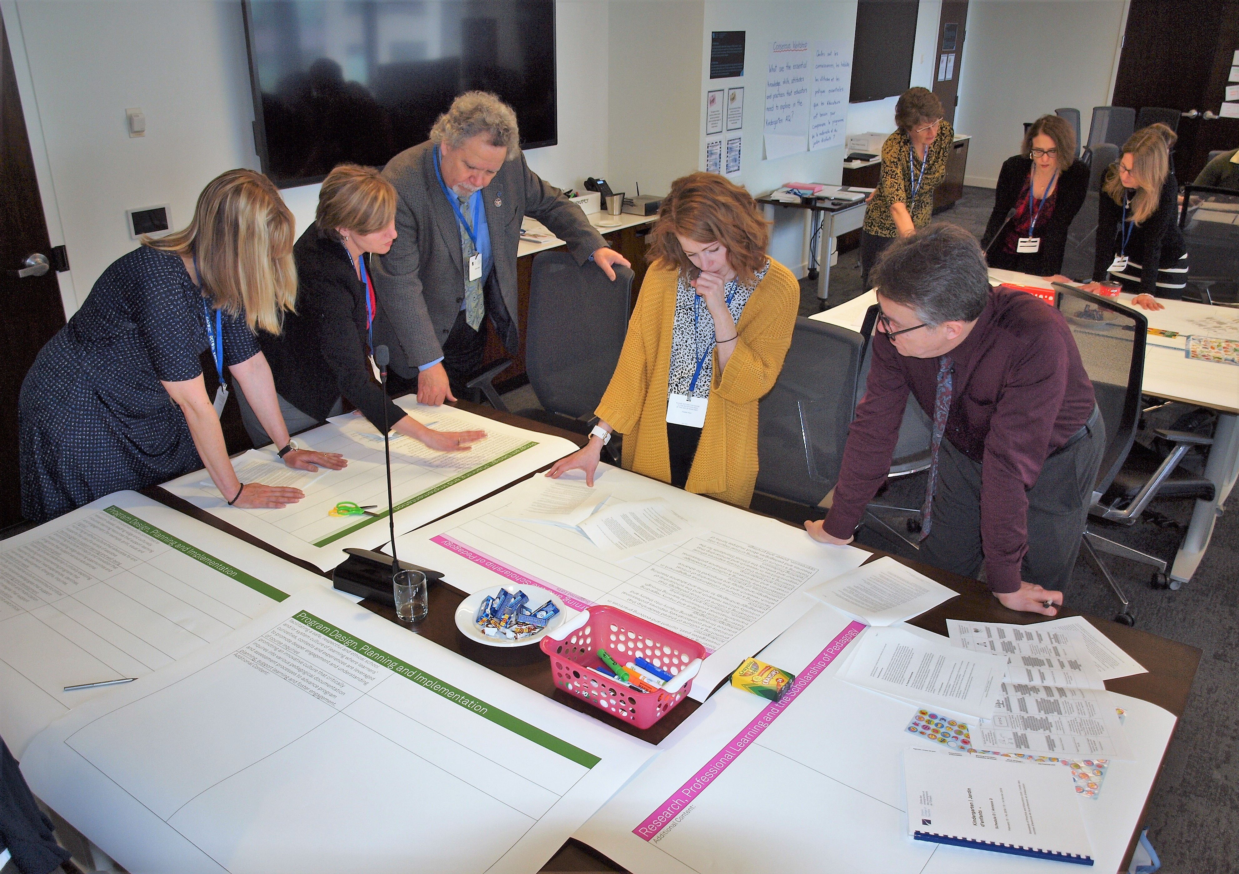 Photo of writing teams at the College's Toronto office working on a project.