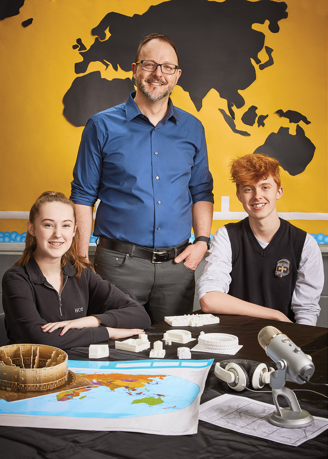 Photo of James Pedrech, Ontario Certified Teacher, standing behind two seated students.