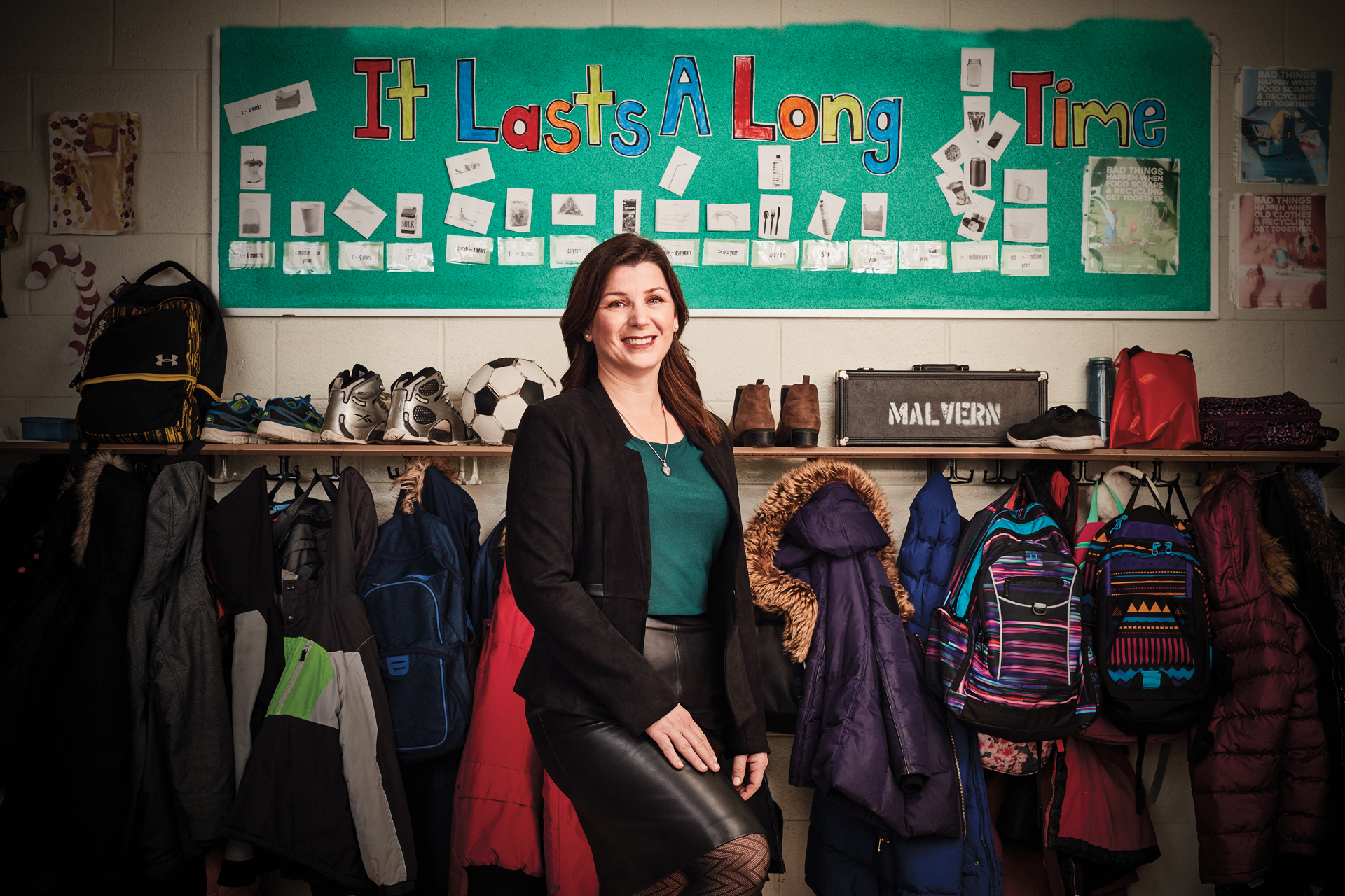 Photo of a teacher smiling in a classroom from an article in the March 2019 issue of 'Professionally Speaking'.