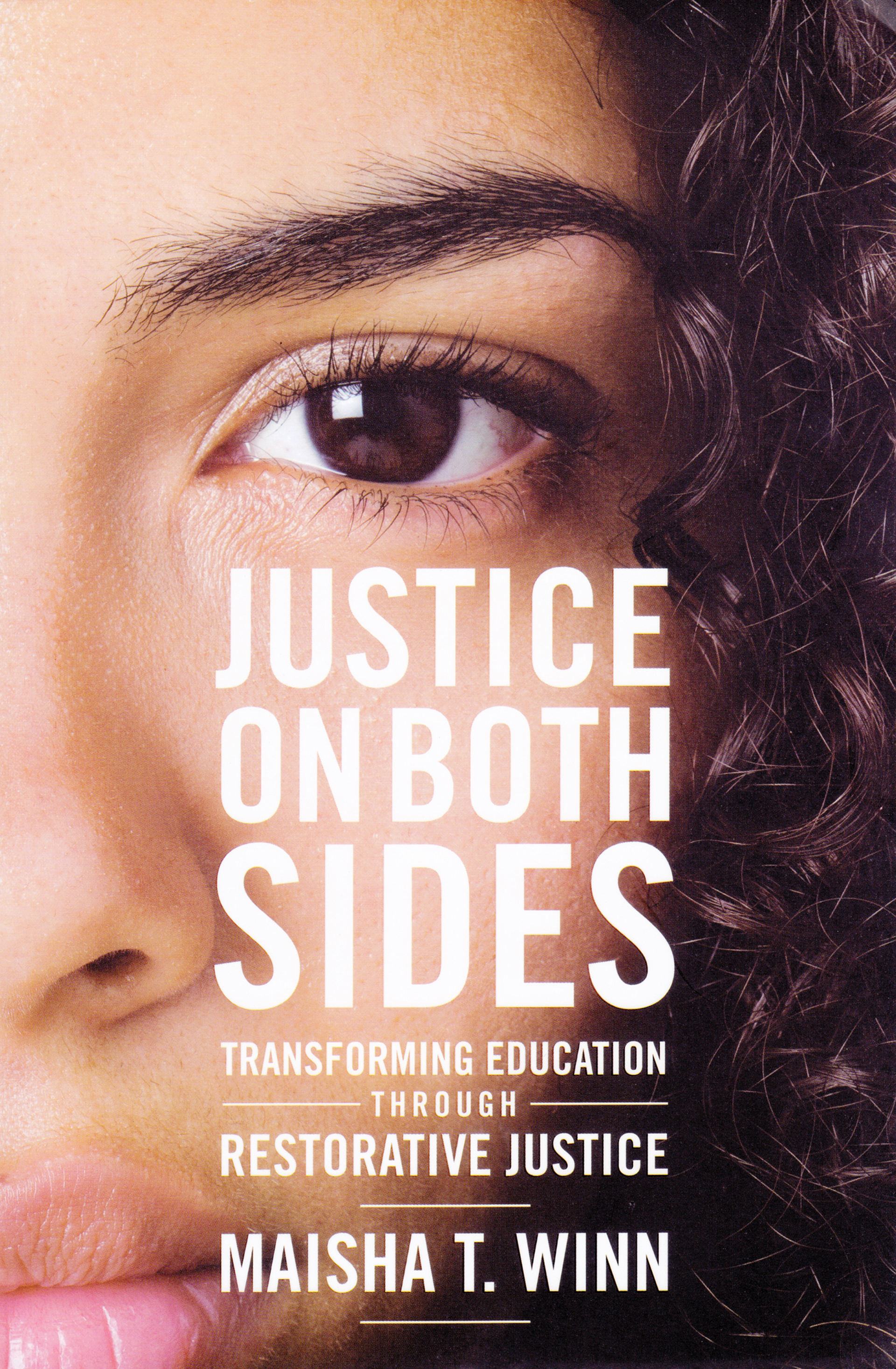 Book cover of 'Justice on Both Sides.' The cover is a close-up photo of half a face.