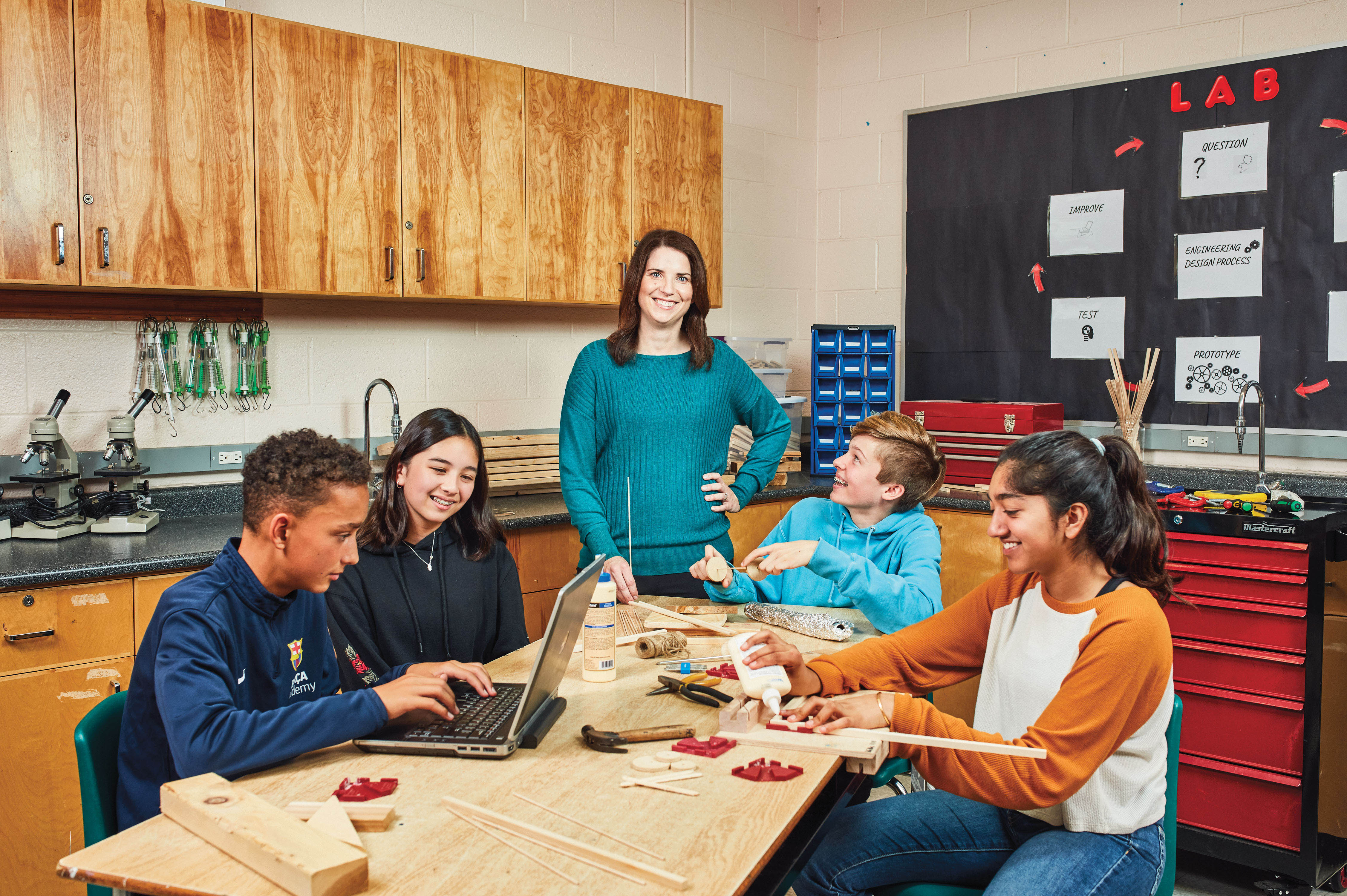 Photo of Lynn Wilkins, Ontario Certified Teacher, standing in a classroom surrounded by students.