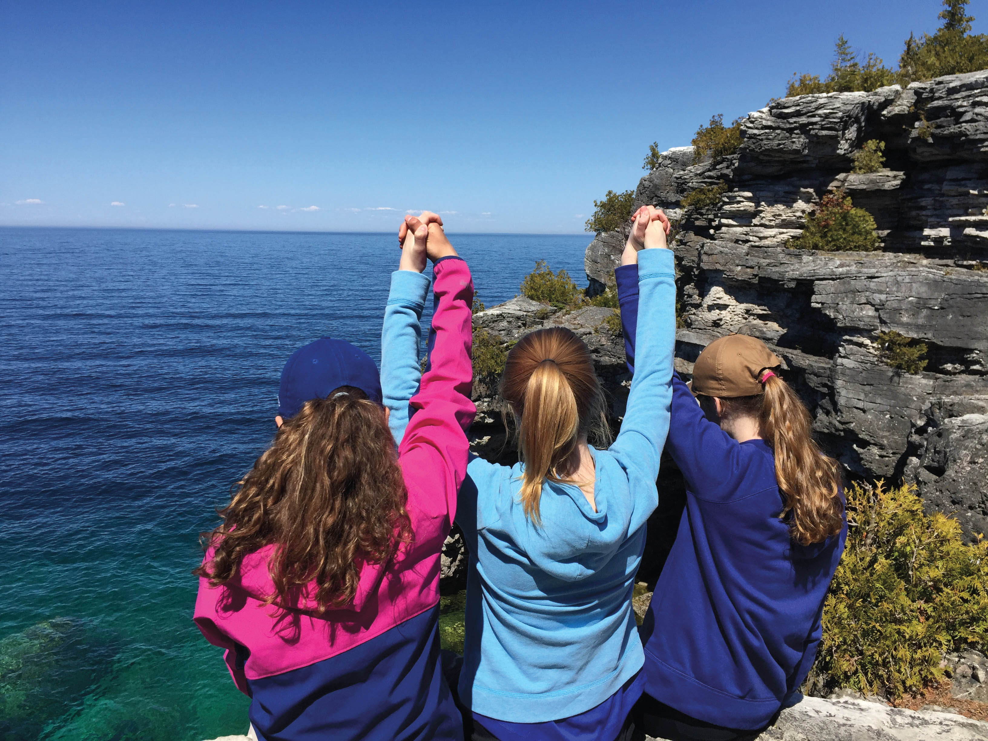 Students holding hands at a lake near Bruce Peninsula National Park