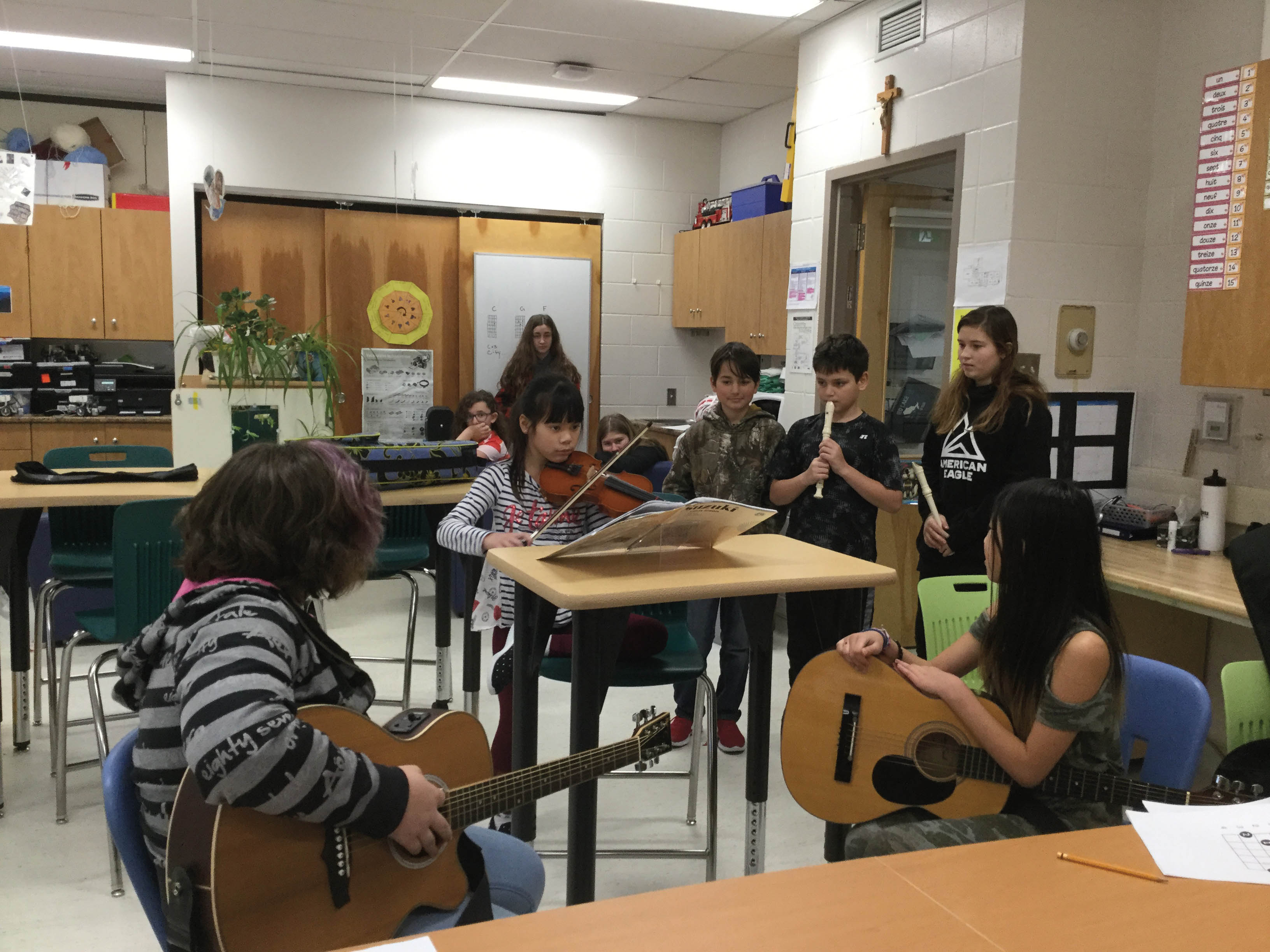 Students playing musical instruments in a classroom