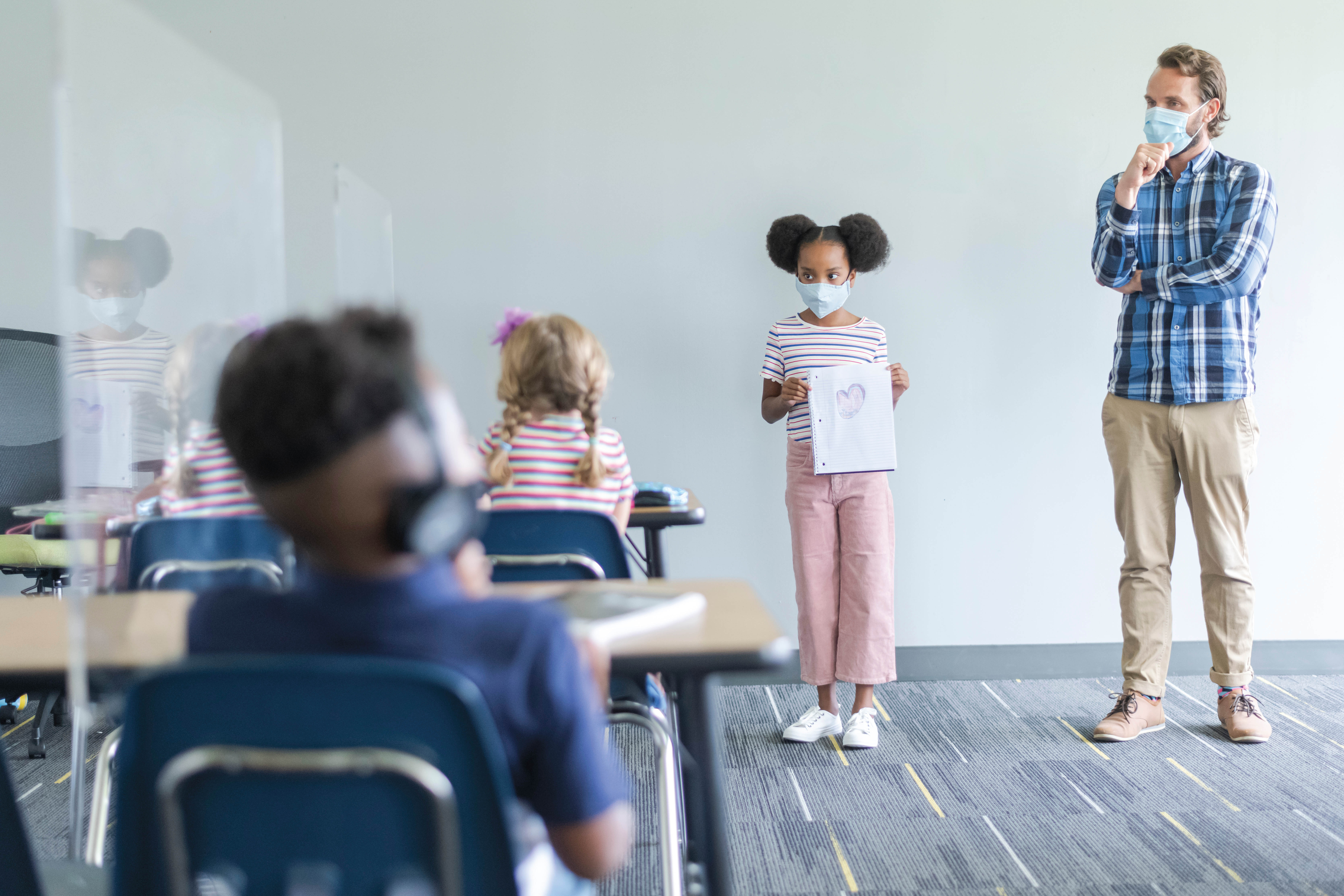 A student shows their work to their class.