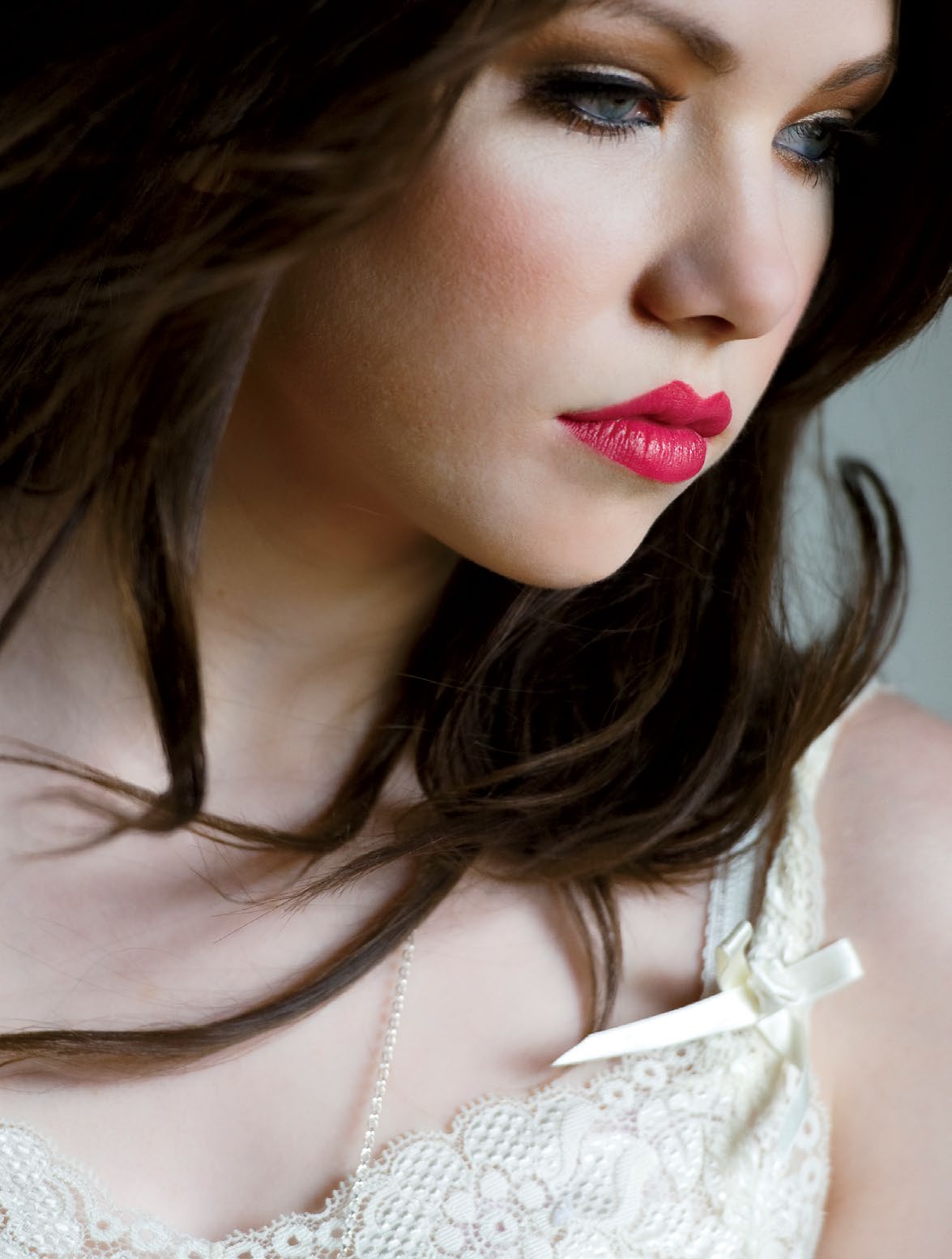 A close up photo of singer, songwriter and actress Carly Rae Jepsen. Carly Rae is looking away from the camera with a somber expression.