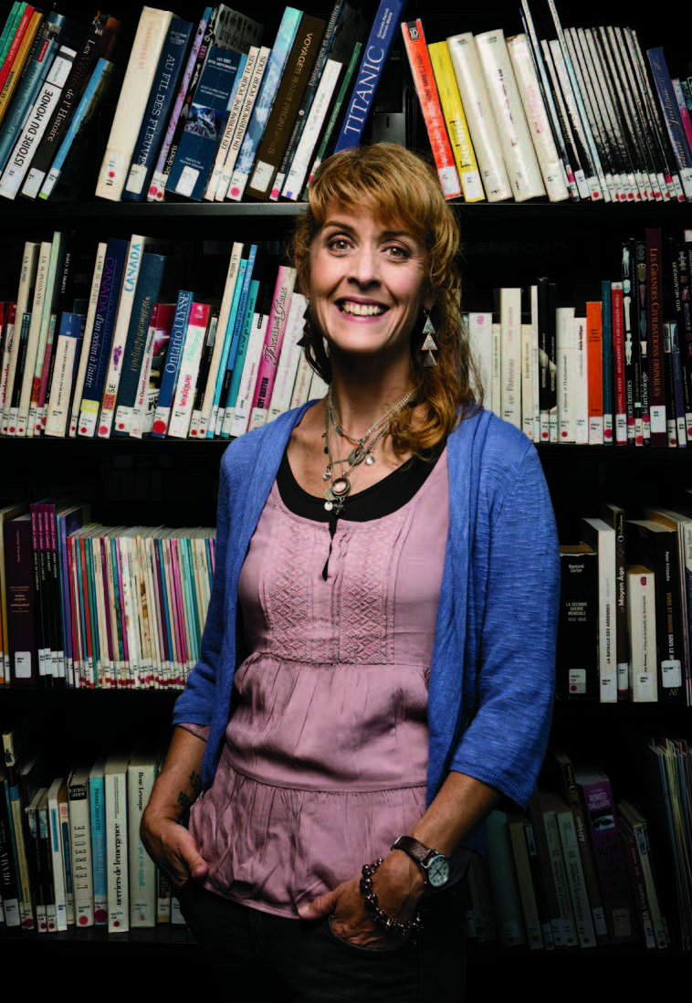 Photo of Lynn Heath, Ontario Certified Teacher, leaning on a locker.