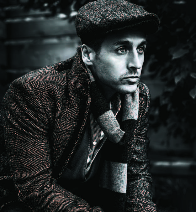 Black and white photo of singer and social activist Raine Maida. Raine is staring away from the camera.