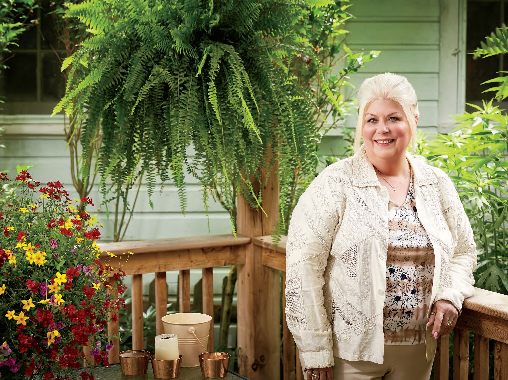 A photo of Geneviève Gareau-Mossé, retired Ontario teacher. Geneviève is standing on a backyard patio in Crystal Beach, Ontario.