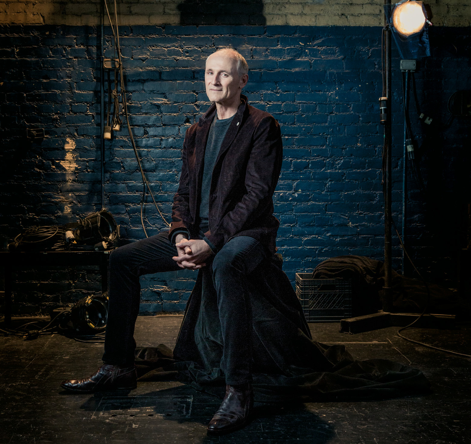 Photo of actor Colm Feore seated with hands clasped.
