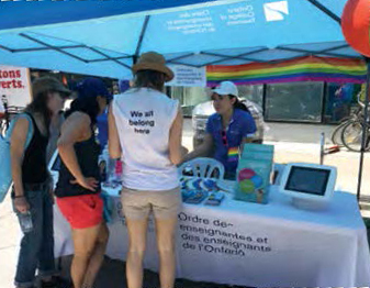 College staff in a booth at the Pride Toronto event